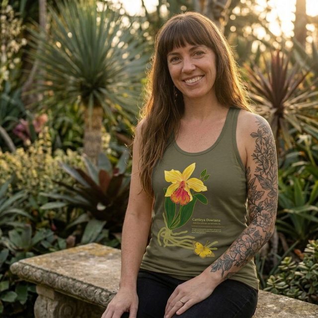 Cattleya Dowiana
(kat-LEE-yuh doh-ee-AH-nuh) – n.

A luminous sun-warmed perennial of uncommon form.

Cattleya blooms with radiance, welcoming all who come near.
Distinct, enigmatic and boldly unforgettable. #marigoldconspiracy
#botanicalart
#wearableart
#natureinspired #botanicalillustration
#plantart
#illustrationart
#graphictees
#textiledesign #cattleya
#orchid
#orchidlove
#tropicalplants
#plantlovers
#artyoucanwear